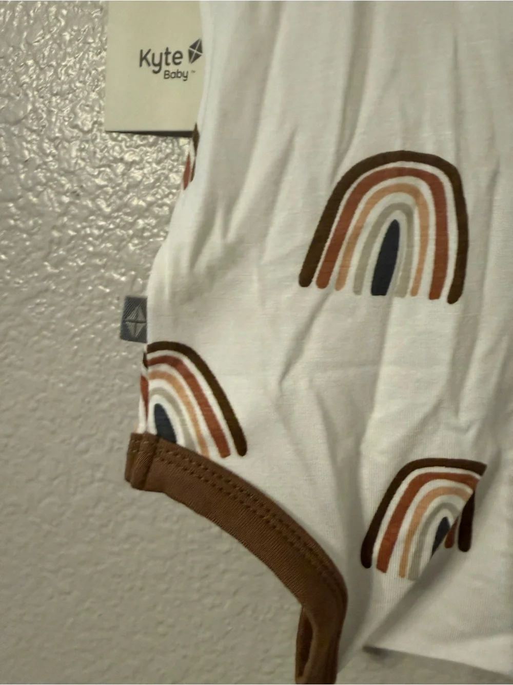 Kyte BABY Cream One-Piece with Brown Trim and Rainbow Print